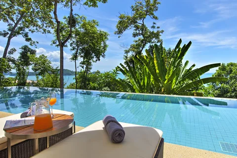 Relax at the poolside loungers overlooking the infinity pool