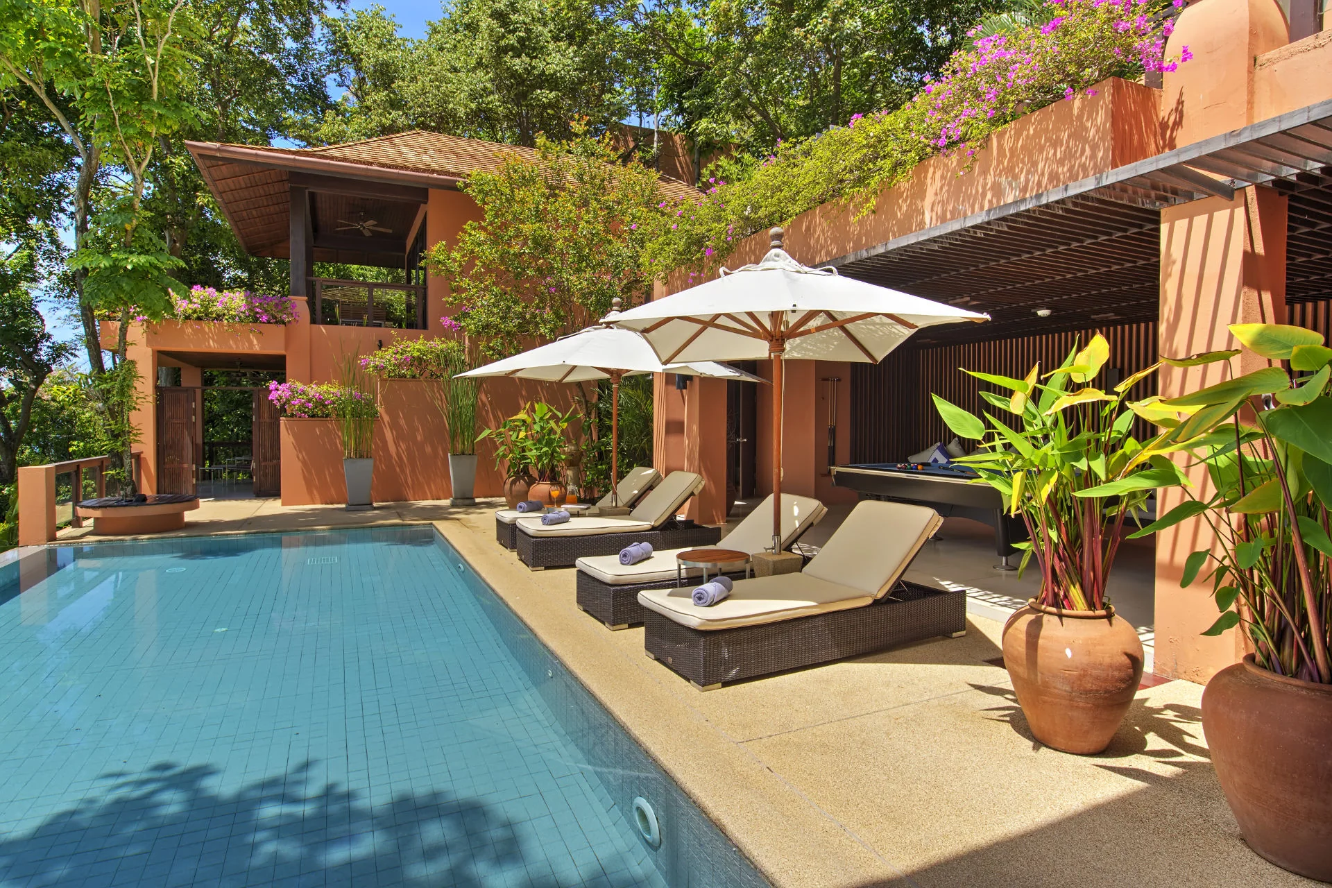 Villa Baan Panwa's private infinity pool and shaded family entertainment area.